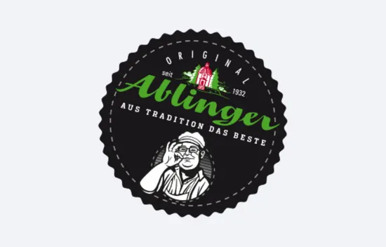 Ablinger-Logo mit einem Mann, der gestikuliert, Text 'Original Ablinger, seit 1932, aus Tradition das Beste'