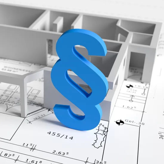 3D-Gebäudemodell auf Architekturplänen mit blauem Paragraphenzeichen